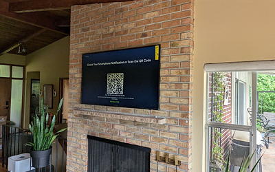 Frame TV mounted over a brick fireplace.