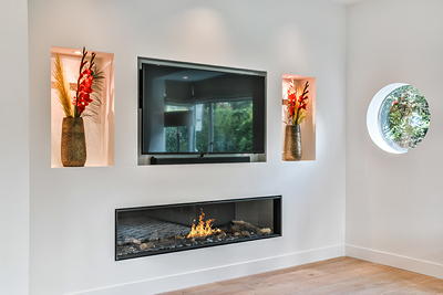 TV mounted above a fireplace in a modern living room — professional over-fireplace TV installation