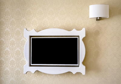 Samsung Frame TV with decorative bezel displaying artwork — flush wall mount with hidden wires