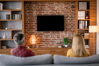 TV mounted on a brick wall in a living room — professional hard surface TV installation